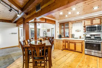 a kitchen with a table and chairs in a room at Summit Hideaway ~ Fantastic Mountain getaway with private hot tub, free Wi-Fi, full kitchen, & more in Big Bear Lake