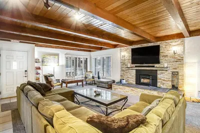 a living room with a couch and a fireplace at Summit Hideaway ~ Fantastic Mountain getaway with private hot tub, free Wi-Fi, full kitchen, & more in Big Bear Lake