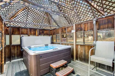 a jacuzzi tub in the inside of a building at Summit Hideaway ~ Fantastic Mountain getaway with private hot tub, free Wi-Fi, full kitchen, & more in Big Bear Lake