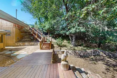 a wooden walkway leading to a house with a staircase at Big Bear 7th Heaven ~ Lakeview Chalet with Hot Tub, Sauna, Grill, Great Deck Views in Fawnskin