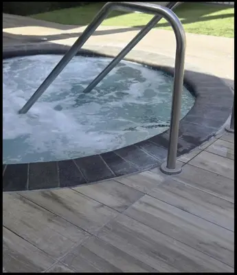 a hot tub with a metal railing in a yard at Luxe Stay Marina Del Rey in Los Angeles
