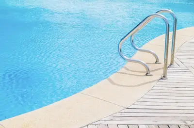 a metal hand rail next to a swimming pool at Luxe Stay Marina Del Rey in Los Angeles