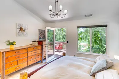 a bedroom with a large bed and a dresser at Forest Views and Fire Pit! Cozy Cabin in Crestline in Crestline