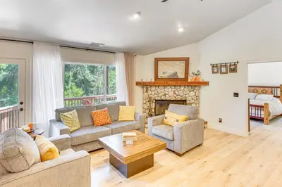 a living room with a couch and a fireplace at Forest Views and Fire Pit! Cozy Cabin in Crestline in Crestline