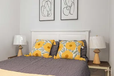 a bedroom with a bed with pillows and two lamps at #Marbella lane - Serene Haven Retreat 3BR in Ontario