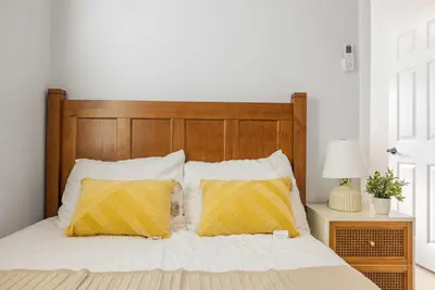 a bedroom with a bed with two yellow pillows at #Marbella lane - Serene Haven Retreat 3BR in Ontario