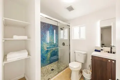 a bathroom with a shower and a toilet and a sink at #Marbella lane - Serene Haven Retreat 3BR in Ontario