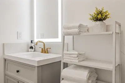 a white bathroom with a sink and a mirror at #Marbella lane - Serene Haven Retreat 3BR in Ontario