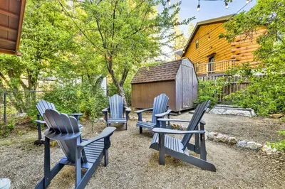 a group of blue chairs sitting in a yard at Orchard Family Cabin Near Historic Big Bear Village Walk to Marina in Big Bear Lake
