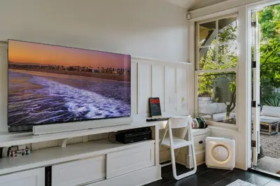 a living room with a large flat screen tv at Venice 2BR and Guest Studio with Tub & Garden in Los Angeles
