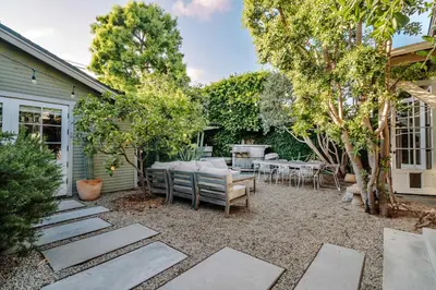 a backyard with a table and chairs and trees at Venice 2BR and Guest Studio with Tub & Garden in Los Angeles