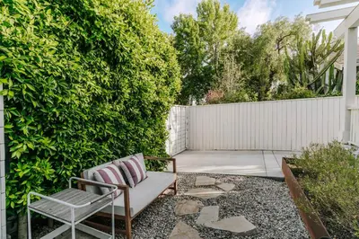 a garden with a bench and a fence at Venice 2BR and Guest Studio with Tub & Garden in Los Angeles