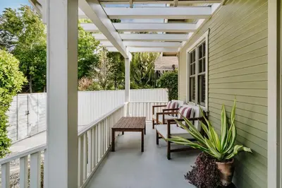 a porch with a pergola and tables and chairs at Venice 2BR and Guest Studio with Tub & Garden in Los Angeles