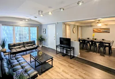 a living room with a couch and a table at Spacious 3 bedroom home by Melrose and 10 minutes to Hollywood Walk of Fame in Los Angeles