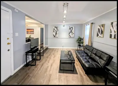 a living room with a couch and a table at Spacious 3 bedroom home by Melrose and 10 minutes to Hollywood Walk of Fame in Los Angeles