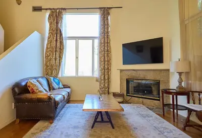 a living room with a couch and a fireplace at Malibu Nature Escape - 2BR Hideaway Nestled in the Woods, Minutes from the Beach in Malibu