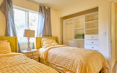 two beds in a bedroom with a window at Malibu Nature Escape - 2BR Hideaway Nestled in the Woods, Minutes from the Beach in Malibu