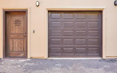 two brown garage doors next to a building at Malibu Nature Escape - 2BR Hideaway Nestled in the Woods, Minutes from the Beach in Malibu