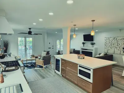 a living room with a kitchen and a living room with a couch at Beach Life in Belmont Shore in Long Beach
