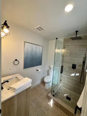 a bathroom with a shower and a sink and a toilet at Beach Life in Belmont Shore in Long Beach