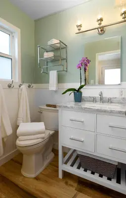 a bathroom with a toilet and a sink and a mirror at Sea La Vie by Paradise Retreats in Ventura