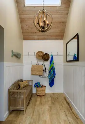 a room with a wooden ceiling and a chandelier at Sea La Vie by Paradise Retreats in Ventura