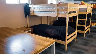 a bunk bed room with two bunk beds and a table at ElMonte Soul in El Monte