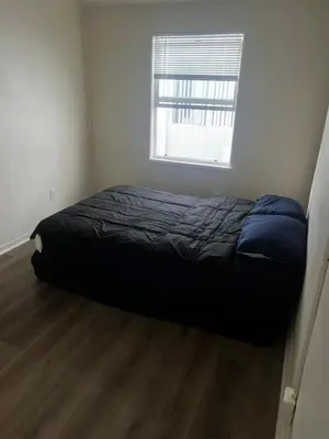a bed in a small room with a window at ElMonte Soul in El Monte