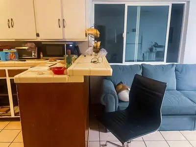 a kitchen with a counter and a blue couch at ElMonte Soul in El Monte