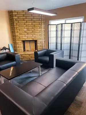 a living room with a couch and a fireplace at ElMonte Soul in El Monte