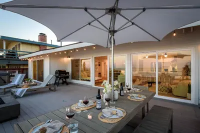 a patio with a table and an umbrella at The Cove at Rincon by Paradise Retreats in Carpinteria