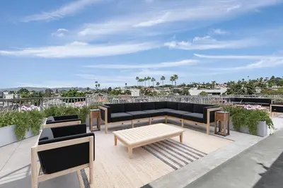 a patio with two couches and a coffee table at Silver Lake 1 Bedroom Condo Suite with Balcony and Parking in Los Angeles