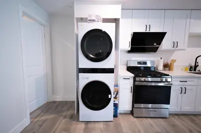 a kitchen with a washer and dryer next to a stove at Modern 2BR2BA Home Near USC Walk to Campus in Los Angeles