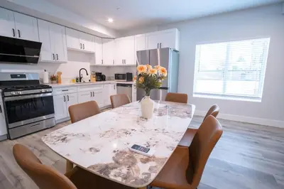 a kitchen with a table with a vase of flowers on it at Modern 2BR2BA Home Near USC Walk to Campus in Los Angeles