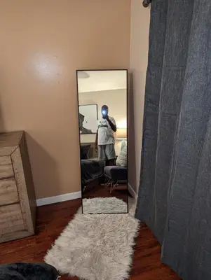 a person standing in front of a mirror in a room at STADIUM LUXURY - CONDO for 4 STEPS AWAY FROM SOFI in Inglewood