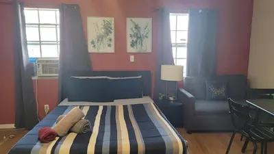 a bedroom with a bed and a couch and a chair at BH Adj, studio spacious BH in Los Angeles