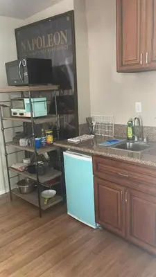 a kitchen with a counter top and a refrigerator at BH Adj, studio spacious BH in Los Angeles