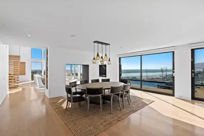 a kitchen and dining room with a table and chairs at Surfside Malibu by Stay Awhile Villas in Malibu