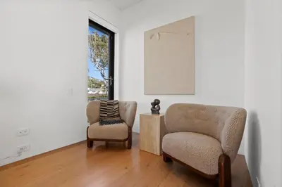 a living room with two chairs and a window at Surfside Malibu by Stay Awhile Villas in Malibu