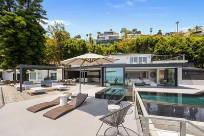 a house with a swimming pool and a patio at Malibu Oceana Bleu by Stay Awhile Villas in Malibu Beach