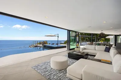 an open living room with a view of the ocean at Malibu Oceana Bleu by Stay Awhile Villas in Malibu Beach