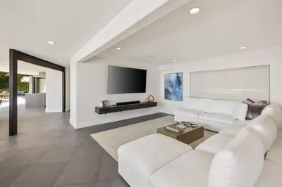 a living room with white furniture and a flat screen tv at Malibu Oceana Bleu by Stay Awhile Villas in Malibu Beach