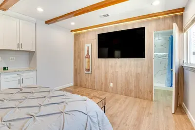 a bedroom with a flat screen tv on a wall at Relax Fireside Hacienda Heights Gem with Patio! in Hacienda Heights