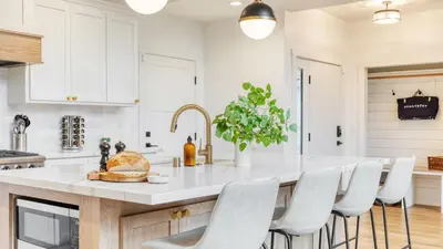 a kitchen with a large island with white counter tops at Luxury Retreat 5mins to the Lake Game Room Fire Pit Howlite by AvantStay in Lake Arrowhead
