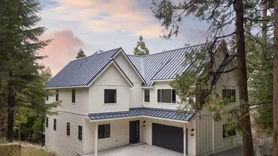 a white house with a gray roof and a garage at Luxury Retreat 5mins to the Lake Game Room Fire Pit Howlite by AvantStay in Lake Arrowhead