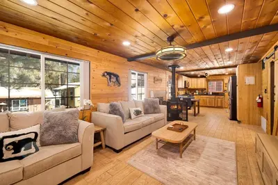 a living room with a couch and a table at Lily's Bear Cabin #2544 in Big Bear Lake