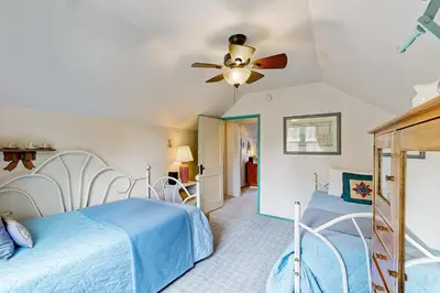a bedroom with a bed and a ceiling fan at Rooster's Den #710 in Big Bear Lake