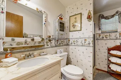 a bathroom with a toilet and a sink and a mirror at Rooster's Den #710 in Big Bear Lake