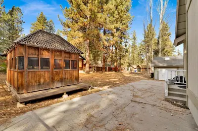a small wooden house sitting next to a road at Summit Hideaway #445 in Big Bear Lake