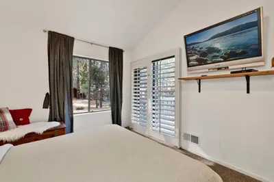 a bedroom with a bed and a tv on a wall at Summit Hideaway #445 in Big Bear Lake
